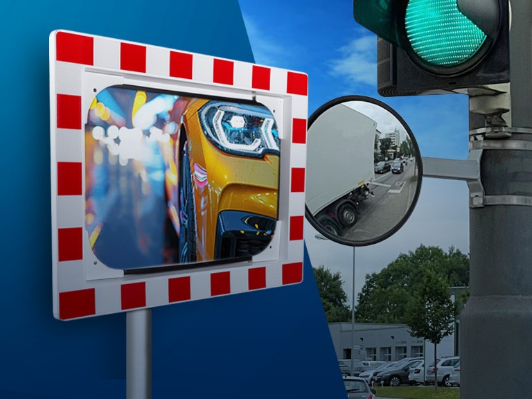 Verkehrsspiegel mit rot-weißem Rand und Ampel-Spiegel auf blauem Grund.