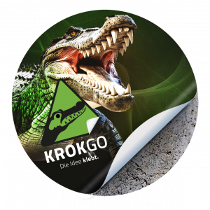 KROKGO Bodenaufkleber mit Krokodil mit geöffnetem Maul, gelbes Warnsymbol und Schriftzug ‚Die Idee klebt‘.