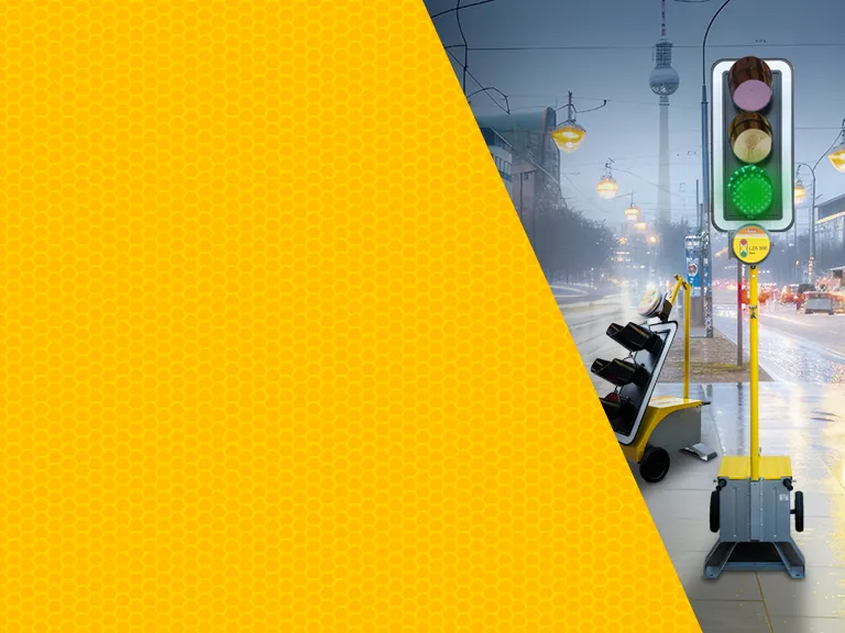 Gelbe Wabenstruktur im Vordergrund, daneben eine mobile Lichtsignalanlage und weitere Absicherungstechnik von Nissen an einer Stadtstraße – Motivbild für die Produktschulung mit Nissen zur Verkehrsabsicherung zum Praxistag ``Verkehrstechnik`` im Schilderwerk Beutha.